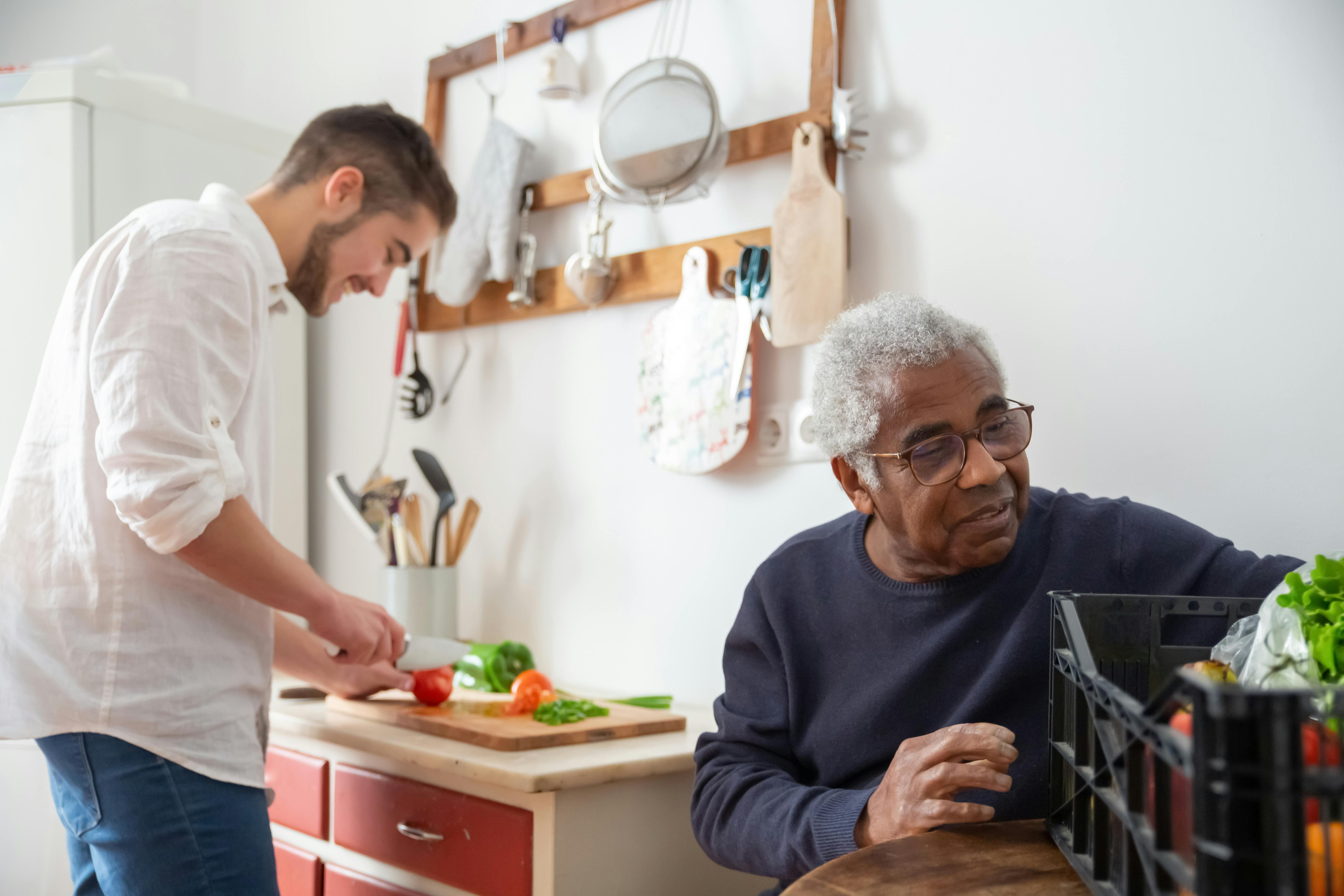 Caregiver and resident enjoying meal preparation together